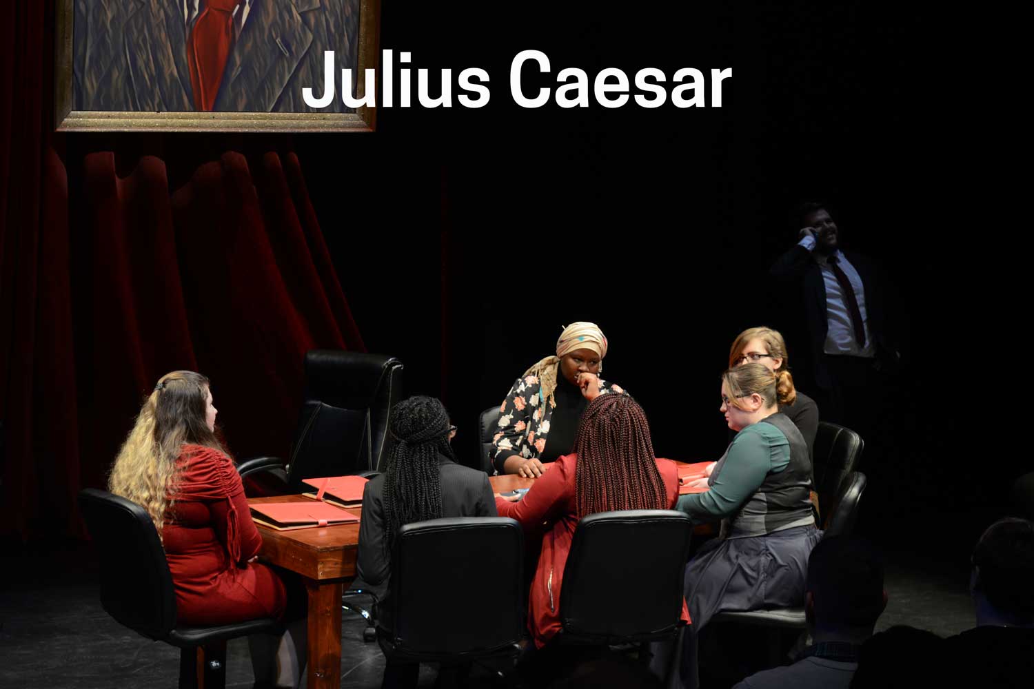 Actors in a play sitting at table