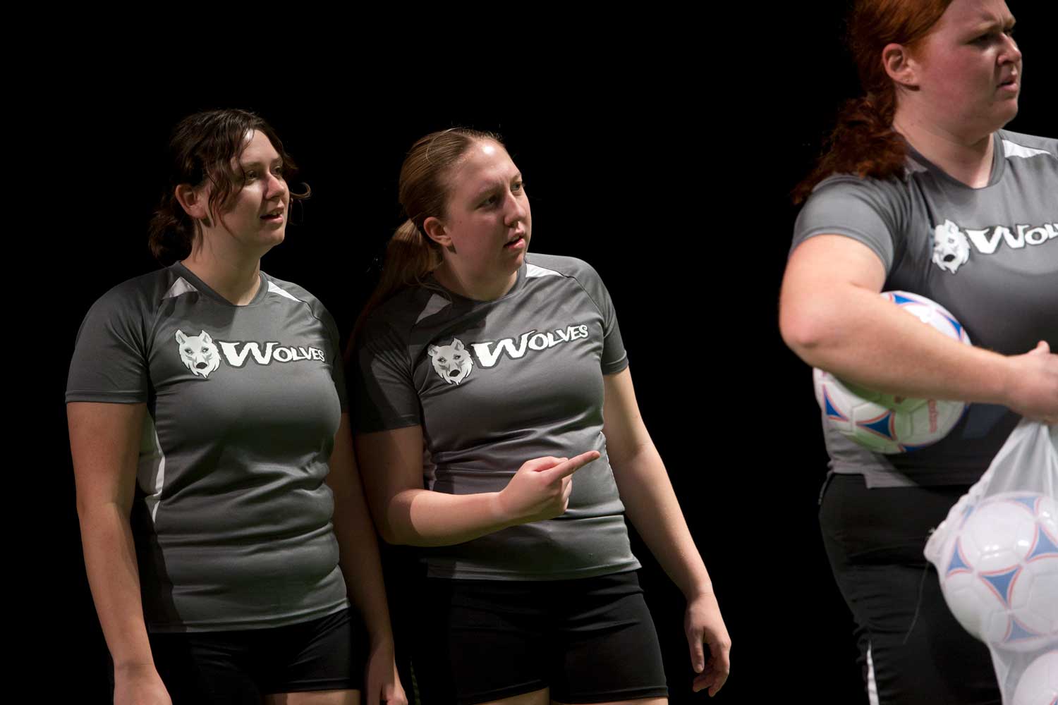 Students in soccer uniforms acting in play